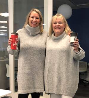 image of two women wearing very similar sweaters