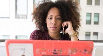 Image of a woman in front of a laptop